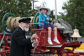[photo, volunteer and visitor on early 1800s hand-pumped engine, Fire Museum of Maryland, Lutherville, Maryland]